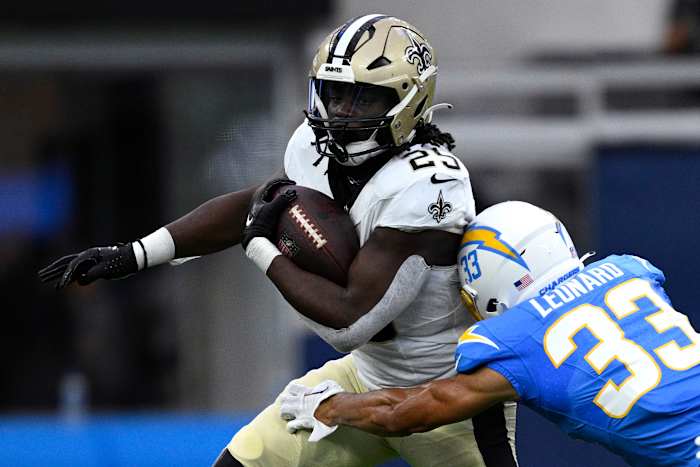 New Orleans Saints running back Kendre Miller (25) runs the ball while defended by Los Angeles Chargers